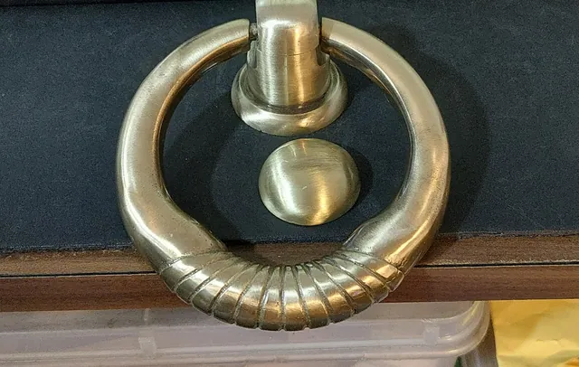 The client's brass ring door knocker with ribbed detail, before refinishing